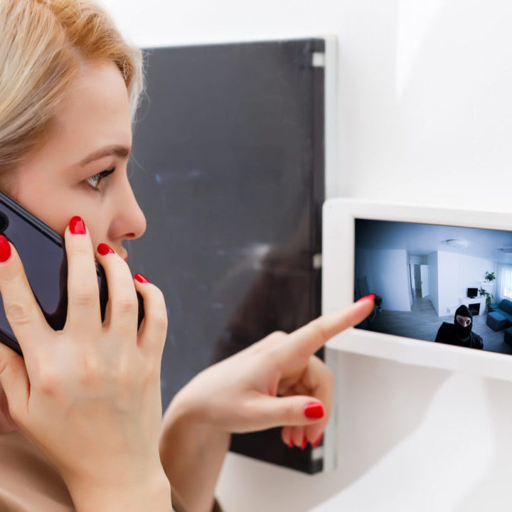 Woman dialing intercom, smart House